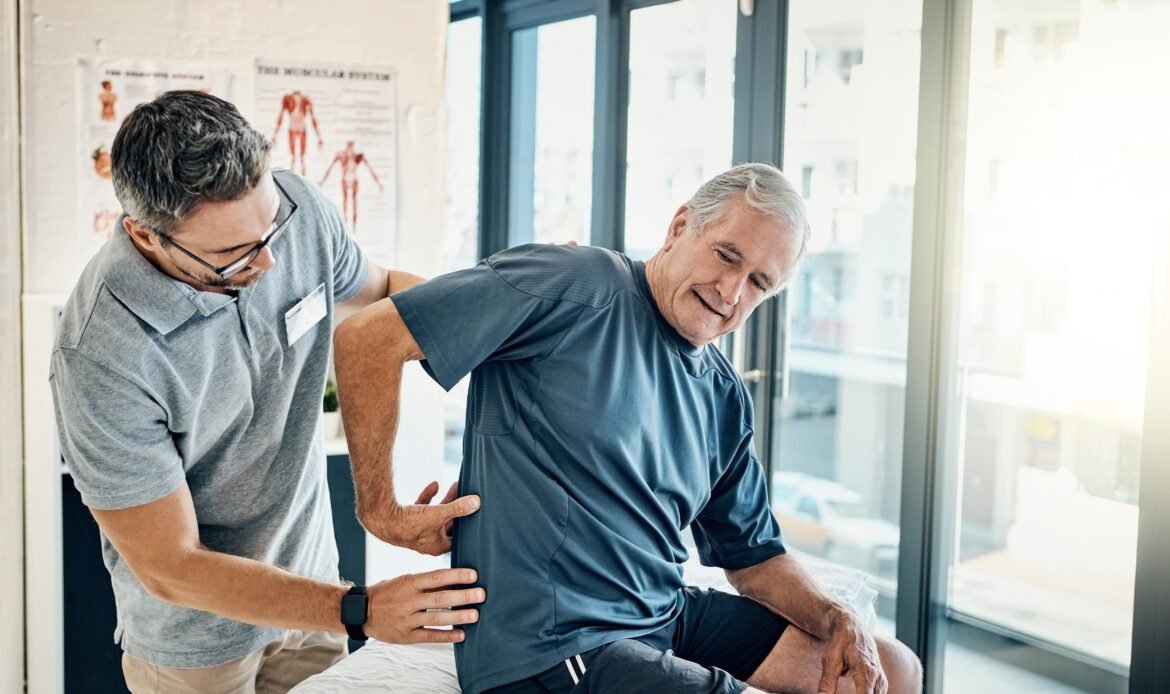 Physical therapy being done at home. Image shows physical therapist assisting patient at home.