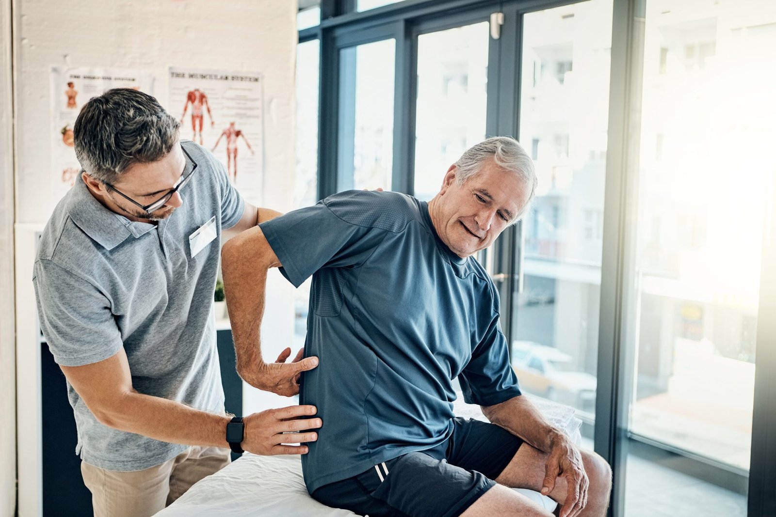 Physical therapy being done at home. Image shows physical therapist assisting patient at home.